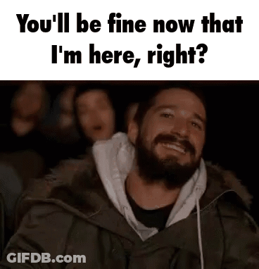 Bearded Man Smiling In Dark Room With Group GIF