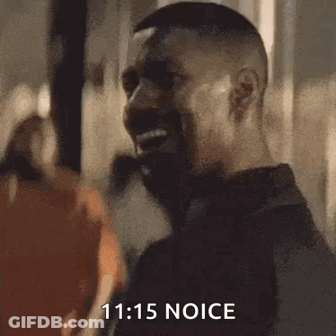 Bearded Man Smiling In Front Of Crowd GIF