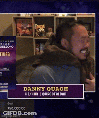 Bearded Man Smiling In Front Of Danny Quach Sign GIF