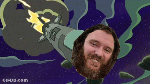 Bearded Man Smiling In Front Of Rocket In Space GIF