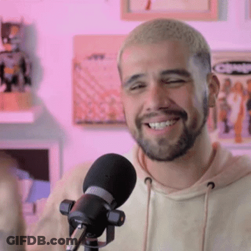 Bearded Man Smiling Into Microphone GIF