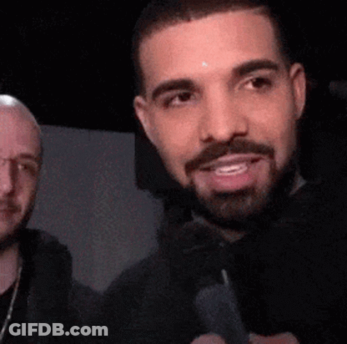 Bearded Man Smiling Next To Glasses Man GIF