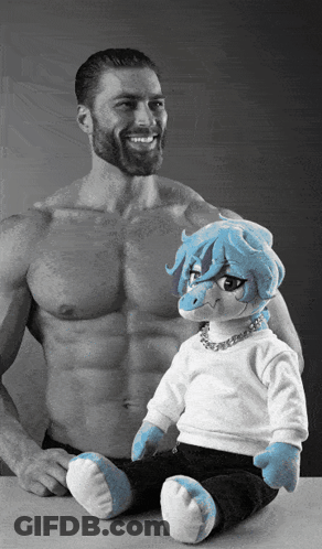 Bearded Man Smiling Next To Stuffed Animal With Blue Hair GIF