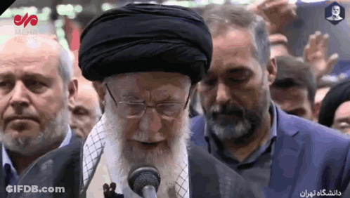 Bearded Man Speaking Into Microphone To Crowd GIF