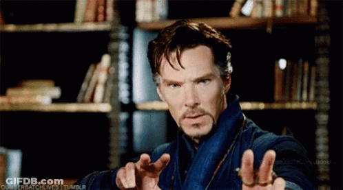 Bearded Man Standing At Bookshelf GIF