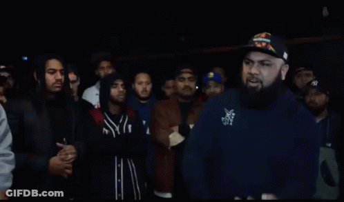 Bearded Man Standing Before Crowd GIF