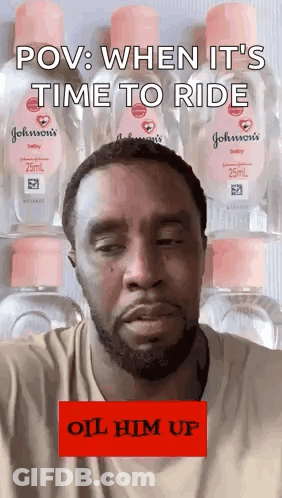 Bearded Man Standing By Baby Oil Bottles GIF