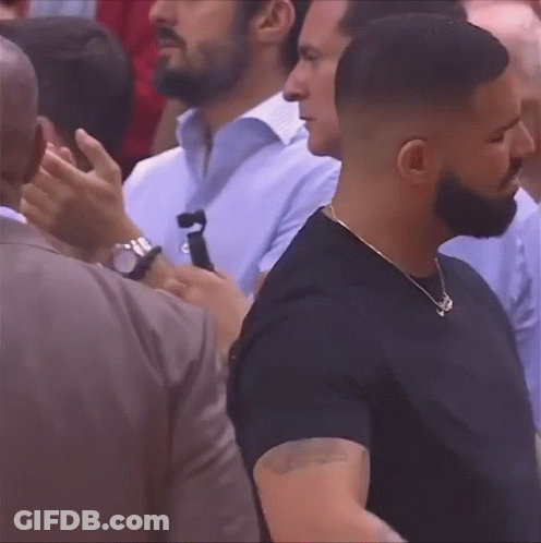 Bearded Man Standing In Crowd GIF