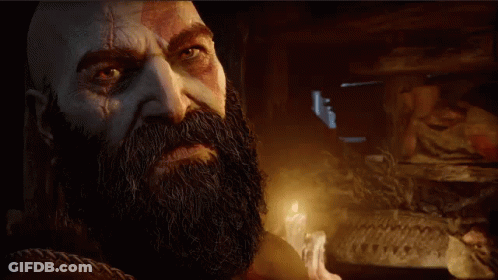 Bearded Man Standing In Dark Room With Candle GIF