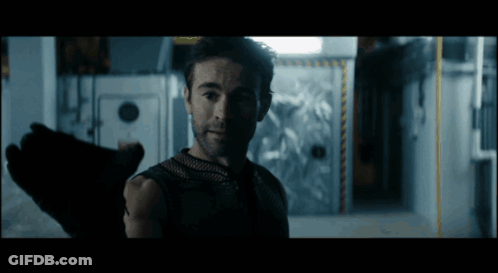 Bearded Man Standing In Dark Room GIF