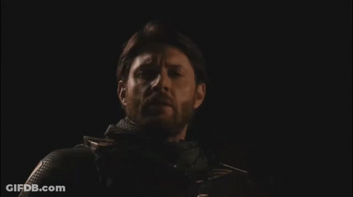 Bearded Man Standing In Darkness With Eyes Closed GIF