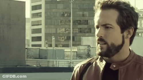 Bearded Man Standing In Front Of Building GIF