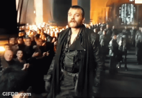 Bearded Man Standing In Front Of Crowd GIF