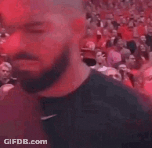 Bearded Man Standing In Front Of Crowd GIF