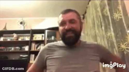 Bearded Man Standing In Front Of Window GIF