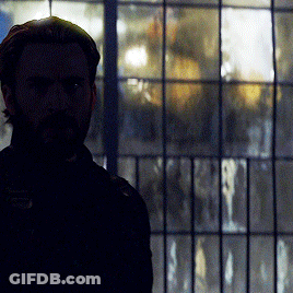 Bearded Man Standing In Front Of Window With Reflection GIF