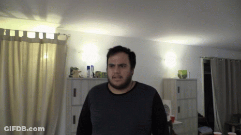 Bearded Man Standing In Living Room GIF
