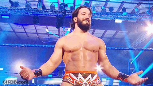 Bearded Man Standing In Wrestling Ring With Arms Outstretched GIF