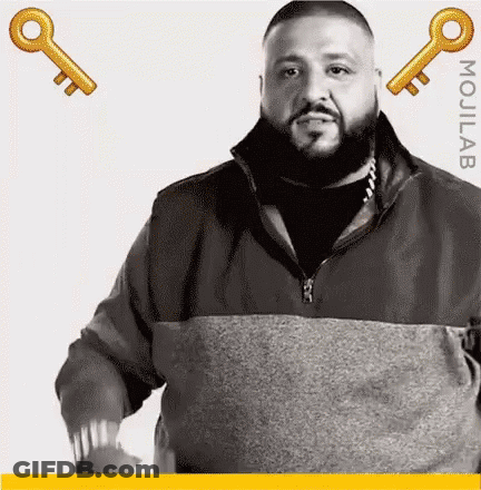 Bearded Man Standing Next To Two Keys GIF
