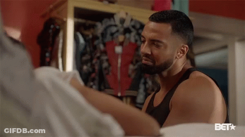 Bearded Man Standing Next To Woman In Bedroom GIF