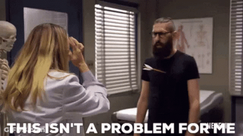Bearded Man Standing Next To Woman In Lab Coat And Skeleton GIF