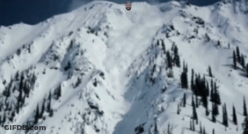 Bearded Man Standing On Snowy Mountain GIF