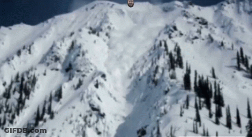 Bearded Man Standing On Snowy Mountain GIF