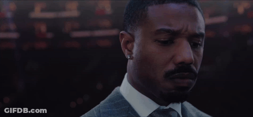Bearded Man Suit Tie Looking At Camera GIF