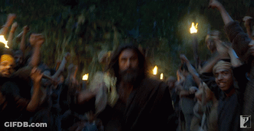 Bearded Man Surrounded By Crowd With Torches GIF