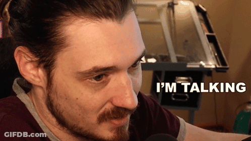 Bearded Man Talking In Front Of Desk GIF
