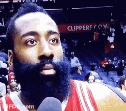 Bearded Man Talking Into Microphone At Clippers Sign GIF