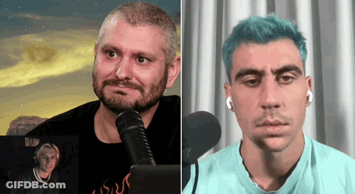 Bearded Man Talking Into Microphone Next To Blue-Haired Man GIF