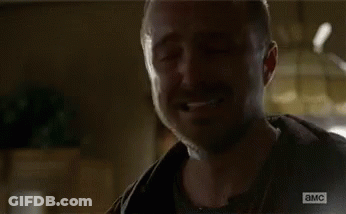 Bearded Man Talking To Man In Dark Room GIF