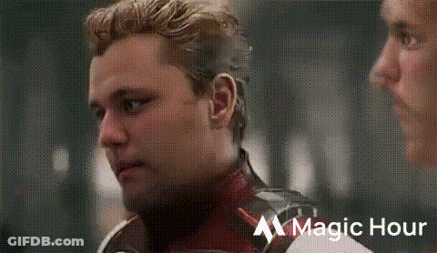 Bearded Man Talking To Man In Superhero Costume GIF