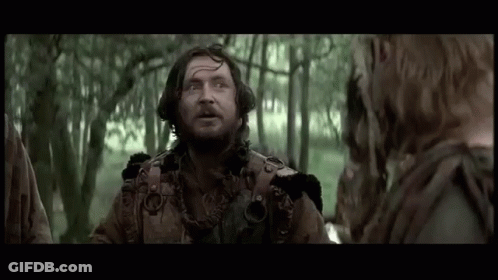 Bearded Man Talking To Woman In Woods GIF