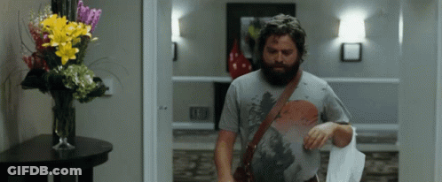 Bearded Man Walking Down Hallway GIF