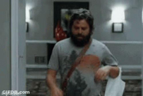 Bearded Man Walking With Towel GIF