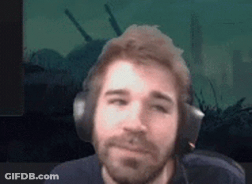 Bearded Man Wearing Headphones Against Green Background GIF