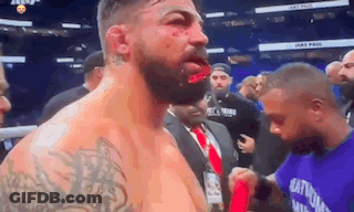 Bearded Man With Bloody Face In Boxing Ring GIF