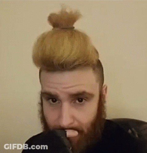 Bearded Man With Bun Looking At Camera GIF