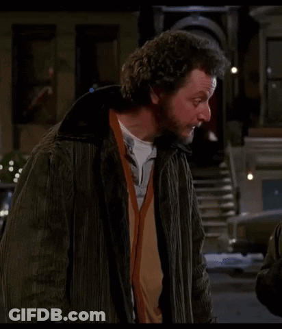 Bearded Man With Curly Hair On City Street GIF