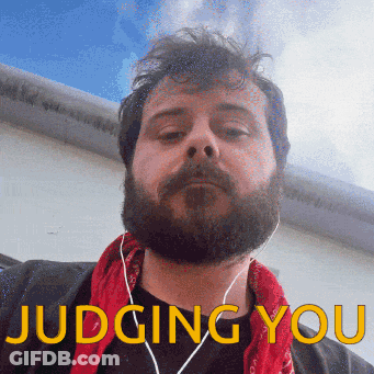 Bearded Man With Ear Buds And Red Bandana Judging You GIF