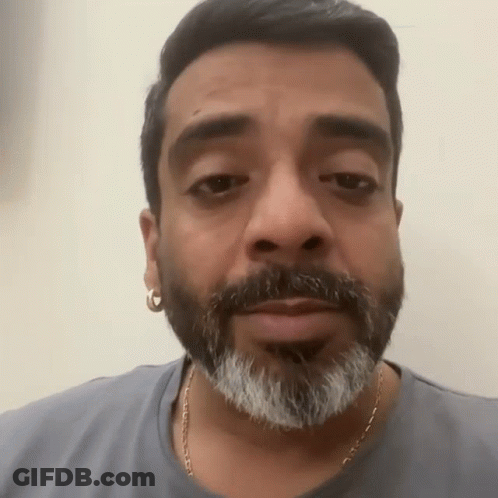 Bearded Man With Earrings In Gray Shirt GIF