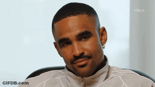 Bearded Man With Earrings In White Jacket Looking GIF