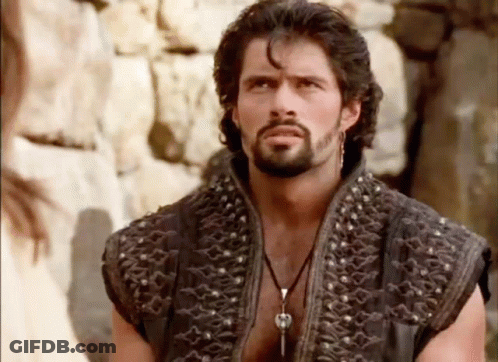 Bearded Man With Earrings Looking At Camera GIF