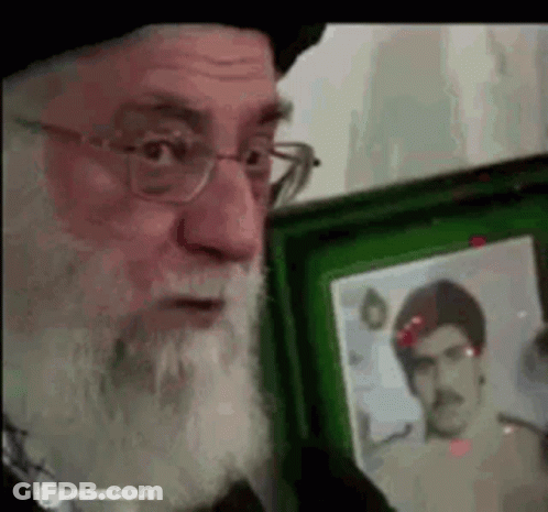 Bearded Man With Glasses Holding Picture In Green Frame GIF