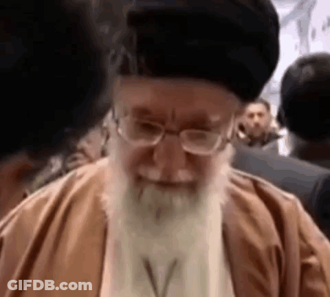 Bearded Man With Glasses Smiling Before Crowd GIF