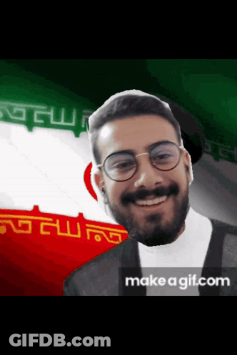Bearded Man With Glasses Smiling By Flag GIF