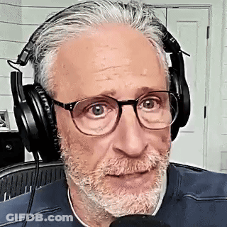 Bearded Man With Glasses Wearing Headphones Talking Into Microphone GIF