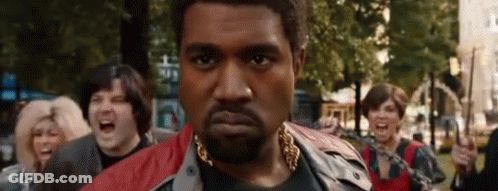 Bearded Man With Gold Chain In Crowd GIF
